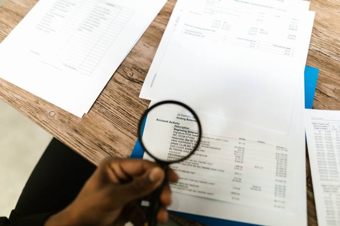 Reviewing property documents with a magnifying glass